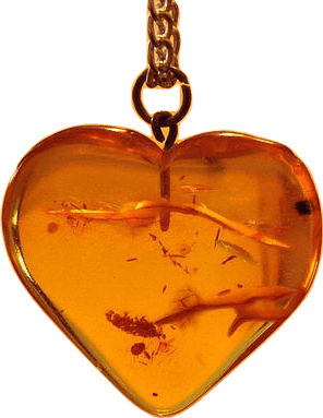 A heart-shaped amber charm on a pendant and chunky wire chain.