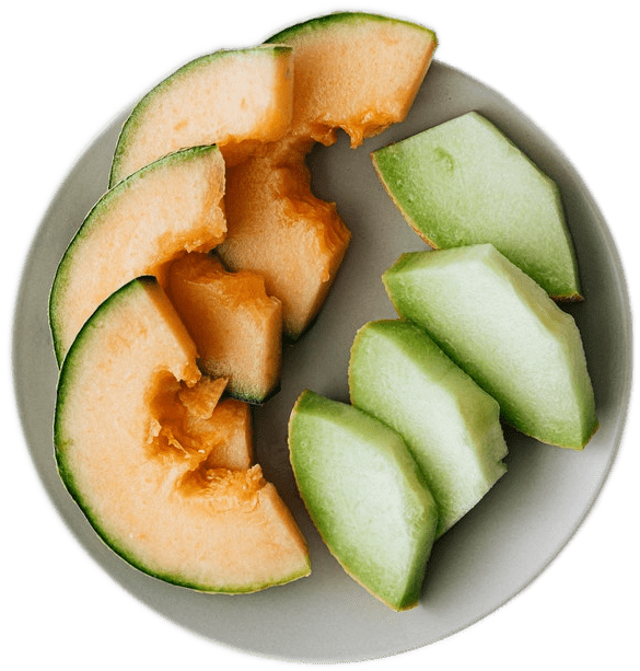 A white plate with four slices apiece of orange cantaloupe and green honeydew melon.