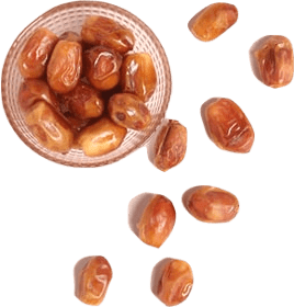 A small glass cup full of dried dates, with more dates scattered around it.