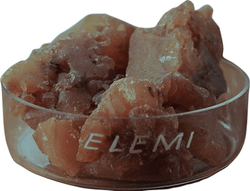 A shallow glass dish of dull brown elemi resin. It is labeled elemi in all capital letters.