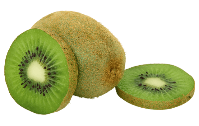 A brown kiwi fruit, with two slices of another kiwi fruit showing its green inside.