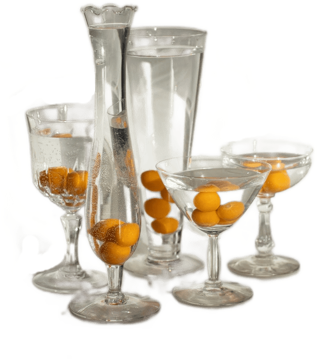 Five ornate glasses of various sizes and shapes filled with water and small orange kumquat fruit.