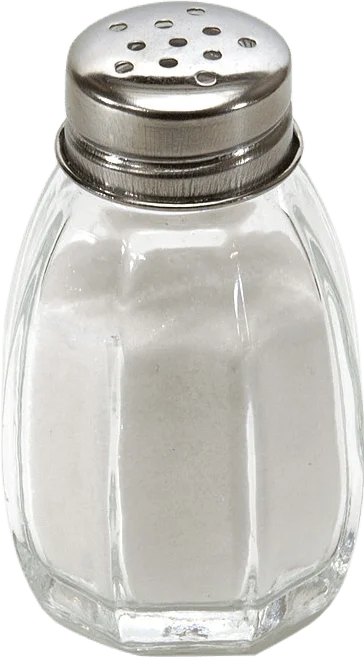 A glass shaker full of salt.