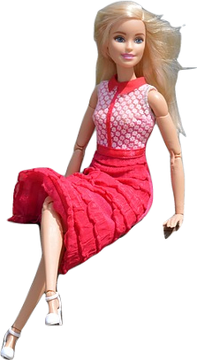 A plastic toy Barbie doll with blonde hair and posable limbs sitting and smiling in a professional pink skirt and blouse.