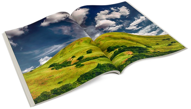 A spread-open photo book with a two-page spread of a colorful landscape photo of a green hill and blue sky and white clouds.