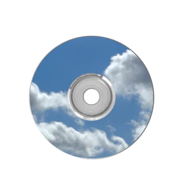 A shiny holographic plastic CD reflecting a blue sky filled with clouds.