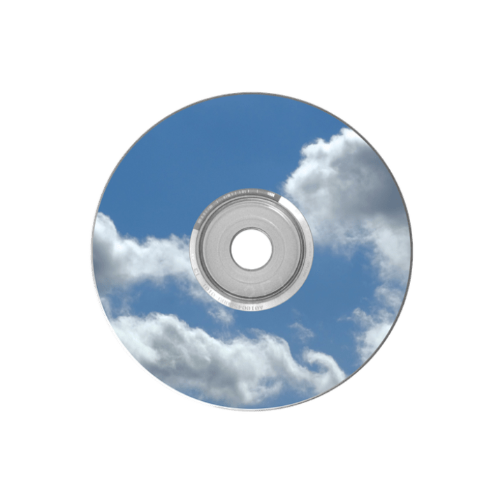 A shiny holographic plastic CD reflecting a blue sky filled with clouds.