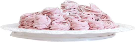 A white plate piled high with light-pink-colored zephyr confectionery treats.