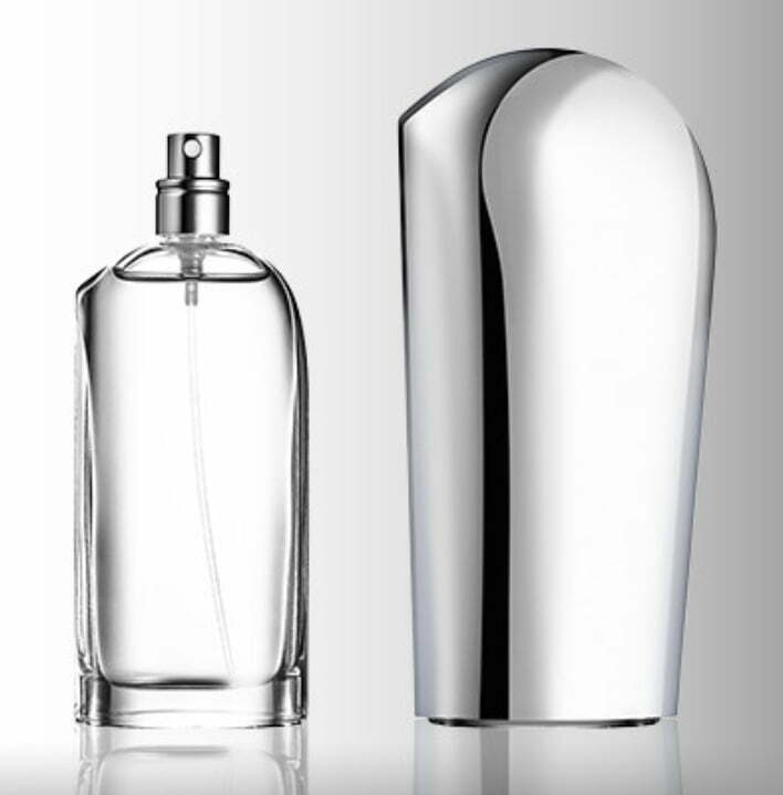 A sleek clear glass bottle of Soul of Motion perfume by Mazda, and its steel-colored metal cover.