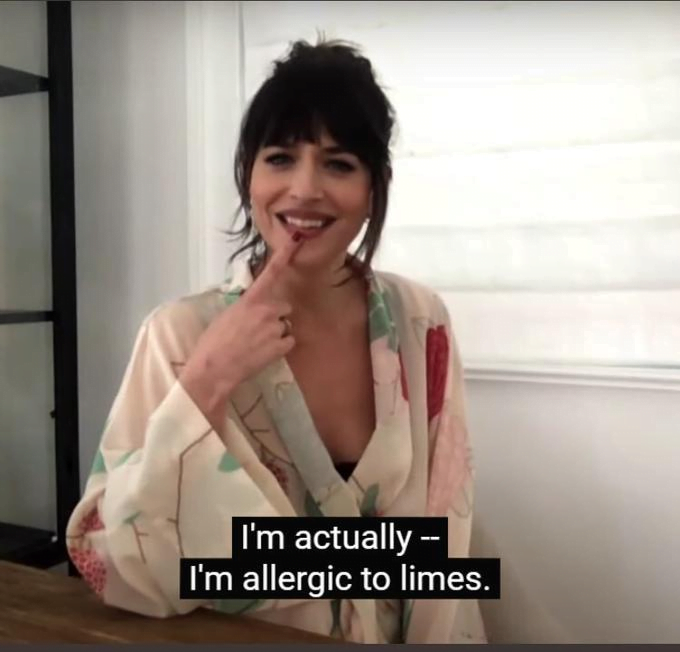 Screenshot of a video in which actress Dakota Johnson sits in a robe at a table and admits, "I'm allergic to limes."