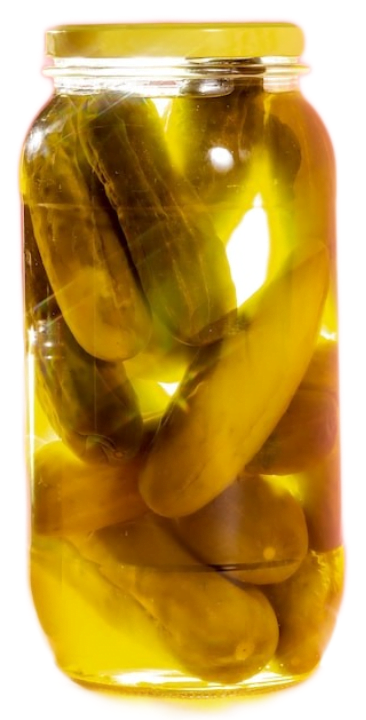 A sealed glass jar filled with cucumber dill pickles in salted vinegar water, backlit by warm yellow sunlight.