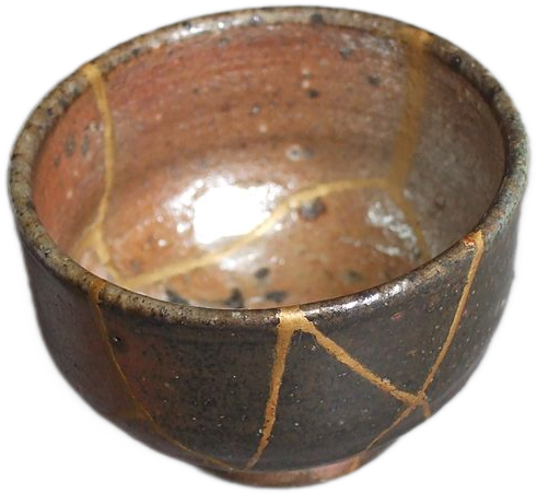 A brown bowl with cracks that have been repaired with gold lacquer in the kintsugi style.