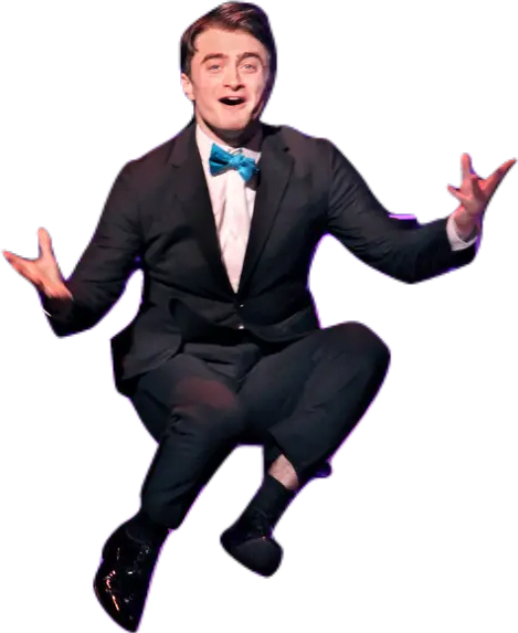 Actor Daniel Radcliffe jumping onstage in the musical adaptation of How to Succeed in Business Without Really Trying.