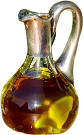 A pourable glass pitcher filled with golden olive oil with a silver handle.