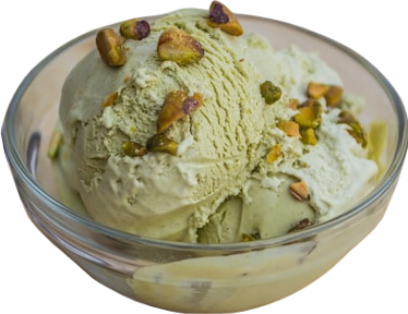 A glass bowl of pale green pistachio ice cream dotted with pistachios.