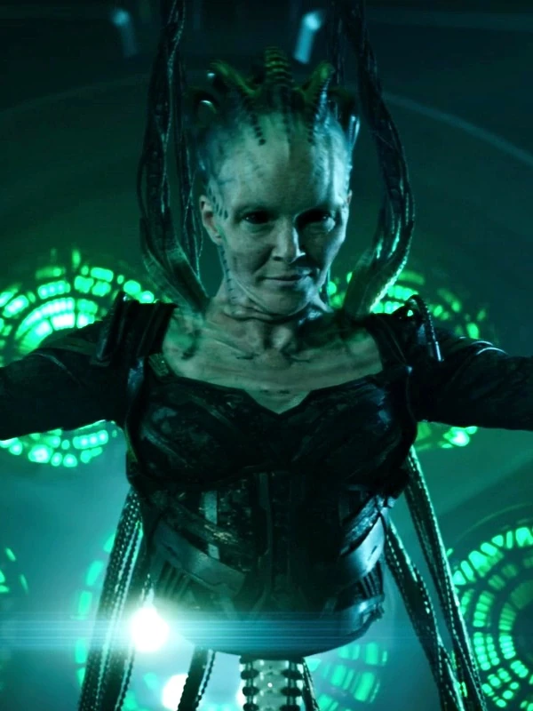 Screenshot from Star Trek showing the Borg Queen, a green-tinged bald cyborg woman.